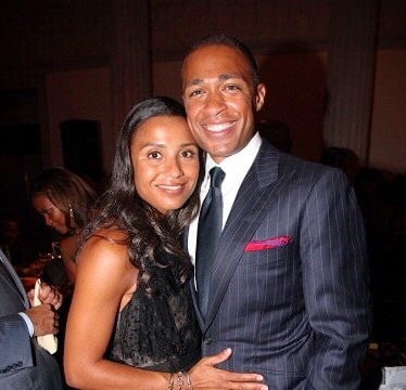 Marilee Fiebig in a black fress with her husband in a white shirt and dark blue suit.